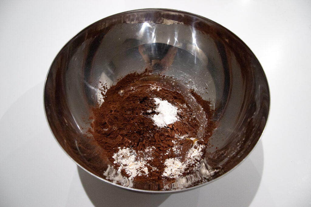 In a large bowl, combine the spelt flour, cocoa powder, baking soda and salt then stir together.